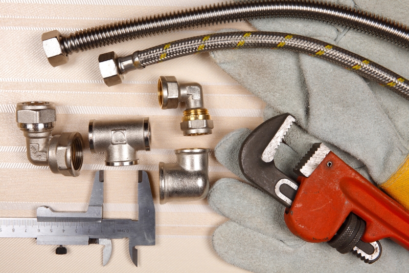 Plumber working on pipes in a West Wickham home